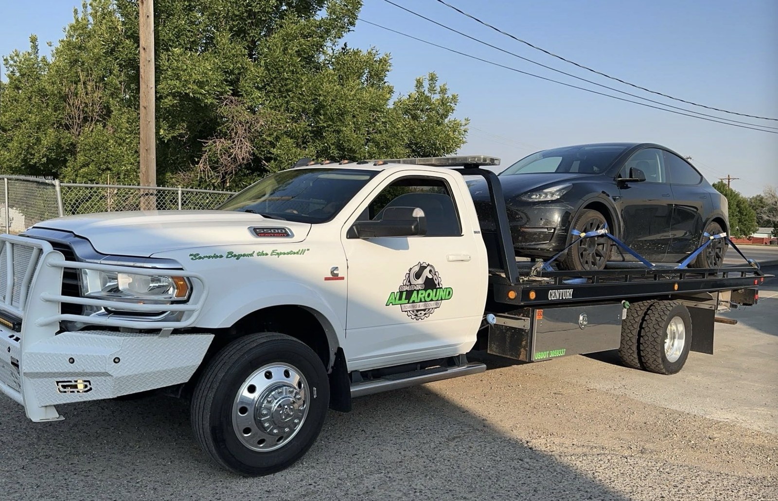 All Around Towing Ram 5500 rollback carrying a black vehicle