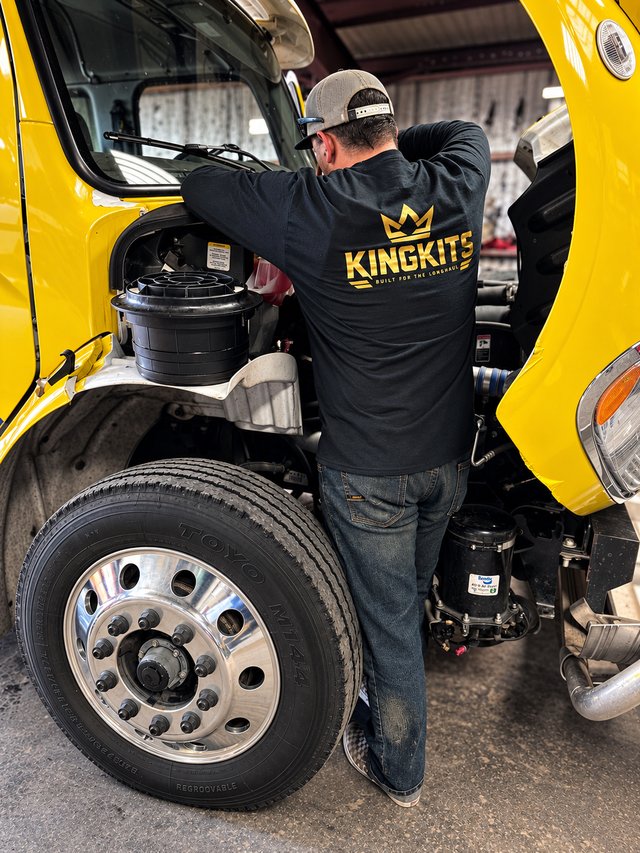 KingKits apparel worn while working on a yellow truck in the shop.