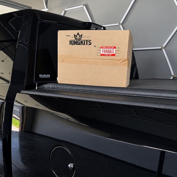 Closed KingKits box resting on the bed cover of a black truck