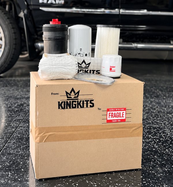 Maintenance filters arranged on a KingKits-branded box, with a black truck behind them